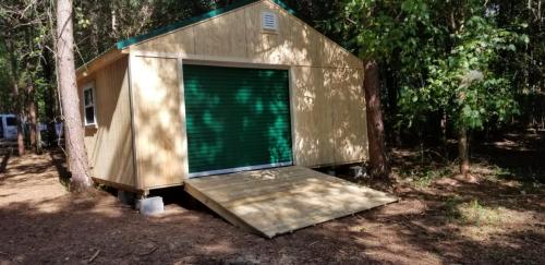 20X20 West Point with 8' walls, garage door, ramp and a metal roof.